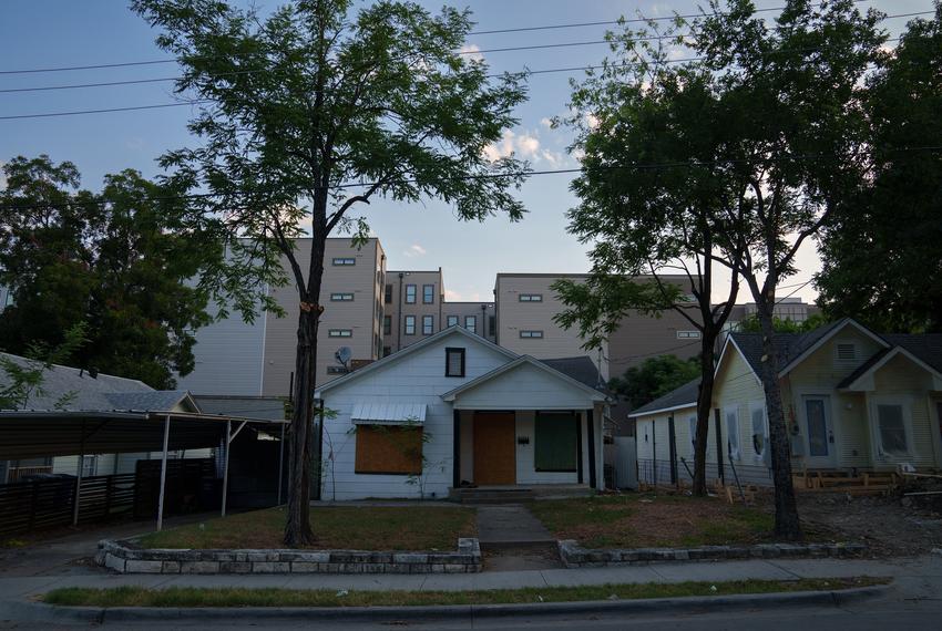 New devlopment peaks from behind older homes in the Oak Cliff neighborhood of Dallas, Texas on July 11, 2024.